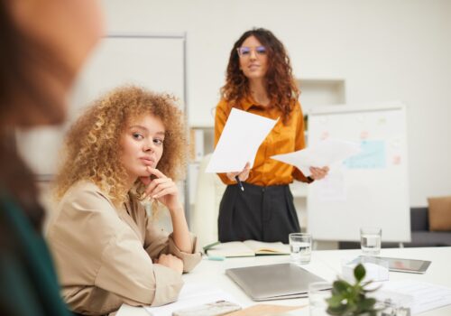 Businesswomen Interacting With Their Colleague